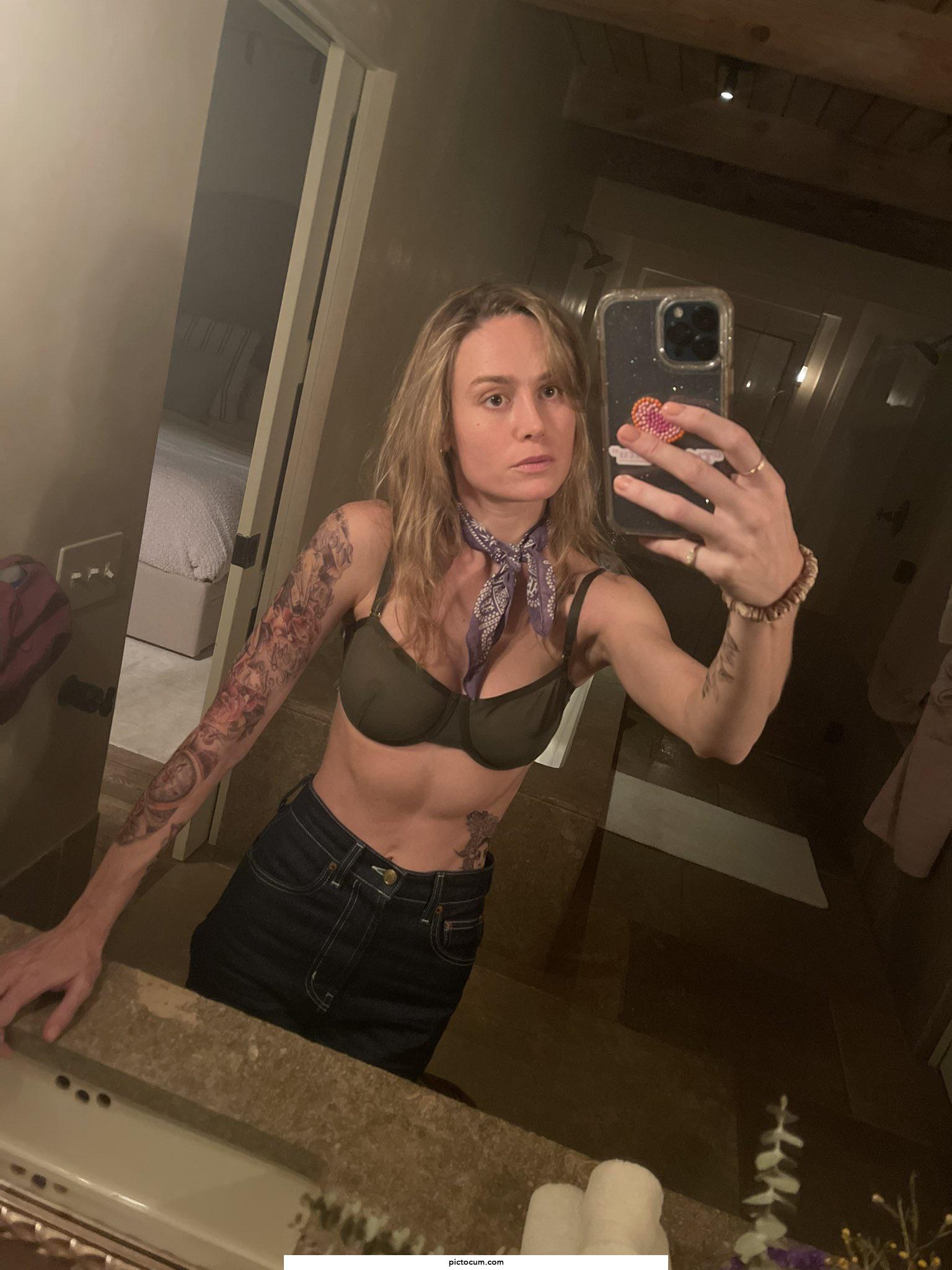 Brie Larson with temporary tattoos and a see through bra